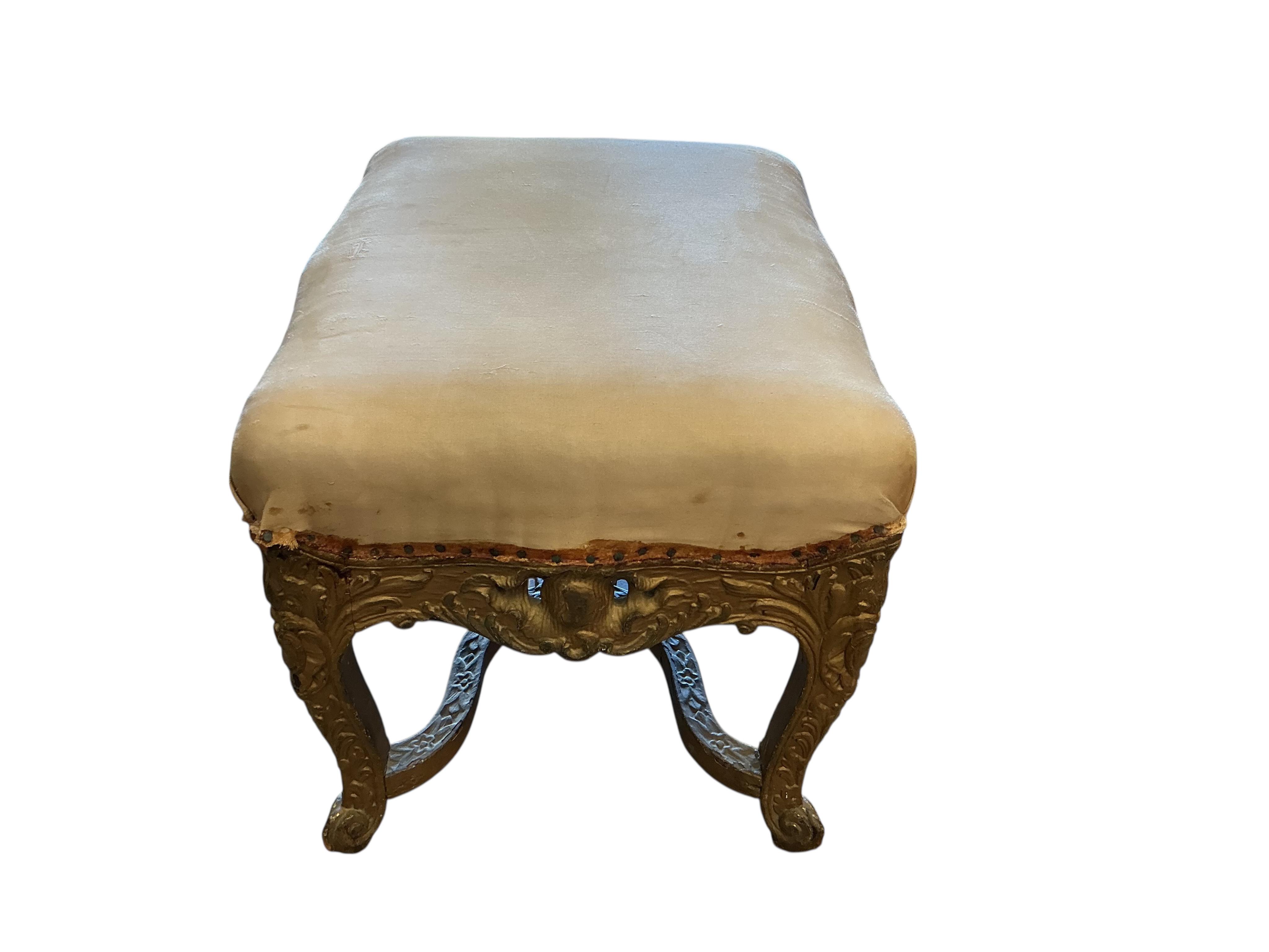 An 18th century carved giltwood stool, width 50cm, depth 40cm, height 40cm